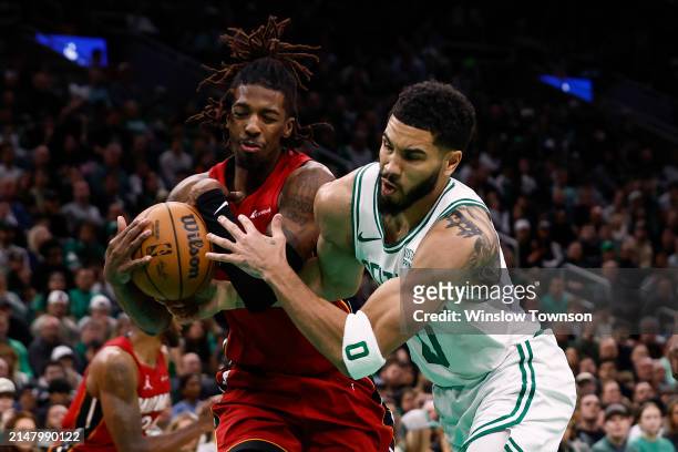 Boston Celtics (0) Jayson Tatum and Miami Heat (4) Delon Wright fight for possession