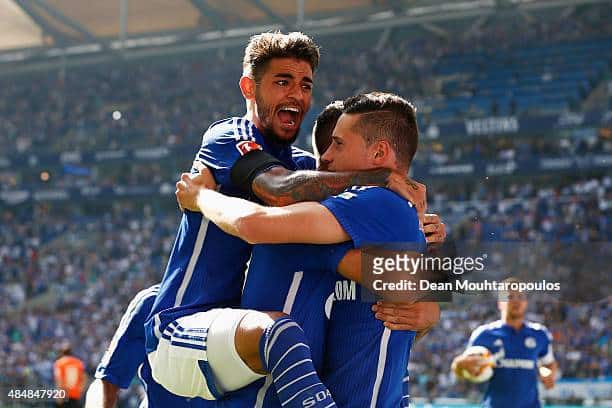 GELSENKIRCHEN, GERMANY - AUGUST 22: Julian Draxler (R) of Schalke celebrates scoring his teams first goal of the game with Junior Caicara during the Bundesliga match between FC Schalke 04 and SV Darmstadt 98 held at Veltins-Arena on August 22, 2015 in Gelsenkirchen, Germany. (Photo by Dean Mouhtaropoulos/Bongarts/Getty Images)