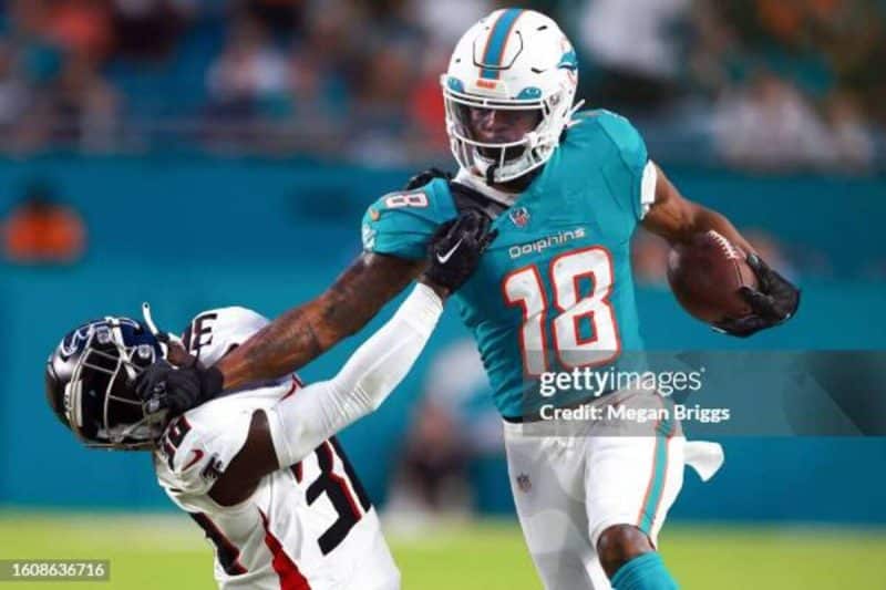 MIAMI GARDENS, FLORIDA - AUGUST 11: Erik Ezukanma #18 of the Miami Dolphins stiff arms Breon Borders #6 of the Atlanta Falcons during the second quarter in a preseason game at Hard Rock Stadium on August 11, 2023 in Miami Gardens, Florida. (Photo by Megan Briggs/Getty Images)