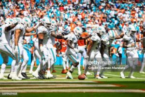 MIAMI GARDENS, FLORIDA - SEPTEMBER 24: Tyreek Hill #10 of the Miami Dolphins and Raheem Mostert #31 celebrate with teammates after Mostert's rushing touchdown during the second quarter against the Denver Broncos at Hard Rock Stadium on September 24, 2023 in Miami Gardens, Florida. (Photo by Carmen Mandato/Getty Images)