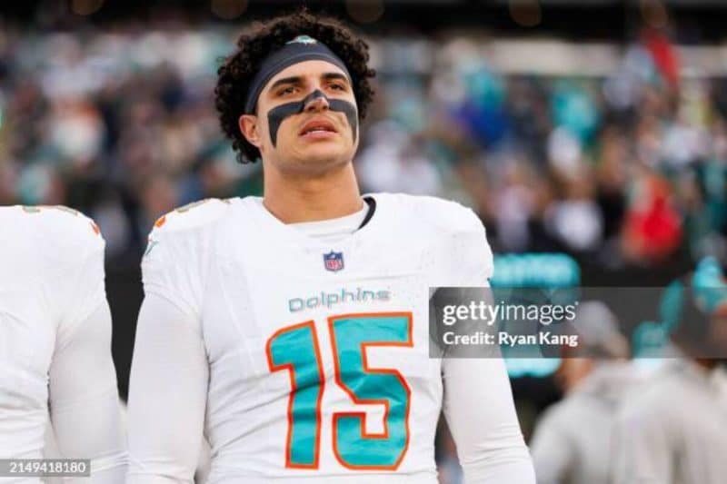 EAST RUTHERFORD, NEW JERSEY - NOVEMBER 24: Jaelan Phillips #15 of the Miami Dolphins looks on from the sideline before an NFL football game against the New York Jets at MetLife Stadium on November 24, 2023 in East Rutherford, New Jersey. (Photo by Ryan Kang/Getty Images)