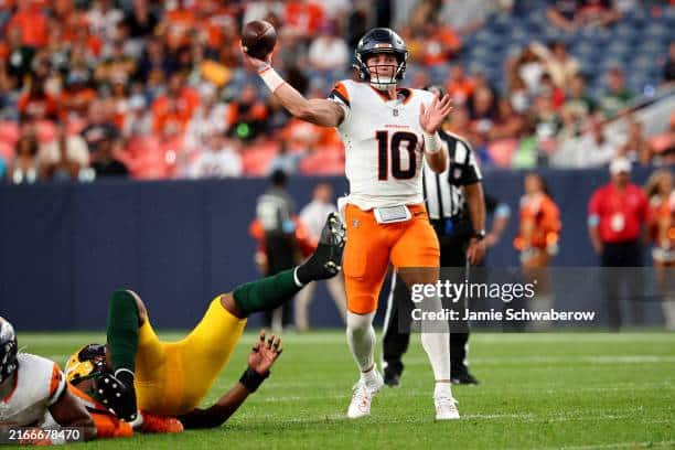 Bo Nix of the Denver Broncos attempts a pass against the Green Bay Packers.