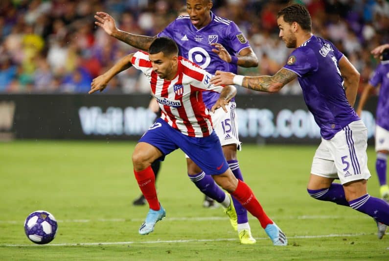 Angel Correa of Atletico Madrid scores late against Real Madrid