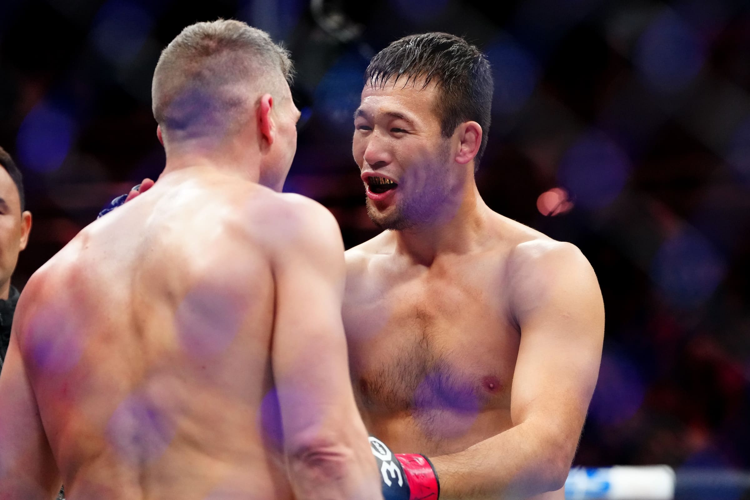 Dec 16, 2023; Las Vegas, Nevada, USA; Shavkat Rakhmonov (red gloves) talks to Stephen Thompson (blue gloves) after defeating him during UFC 296 at T-Mobile Arena. Mandatory Credit: Stephen R. Sylvanie-Imagn Images.