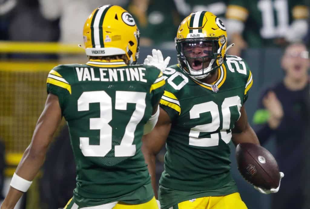 Green Bay Packers safety Rudy Ford (20) celebrates with cornerback Carrington Valentine (37) after intercepting a pass