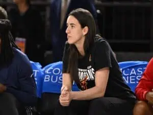 Indiana Fever guard Caitlin Clark looks on from the bench against the Washington Mystics .