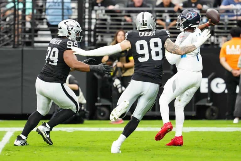 Las Vegas Raiders defensive end Maxx Crosby closes in on Titans QB Cam Ward Image by: Stephen R. Sylvanie-Imagn Images