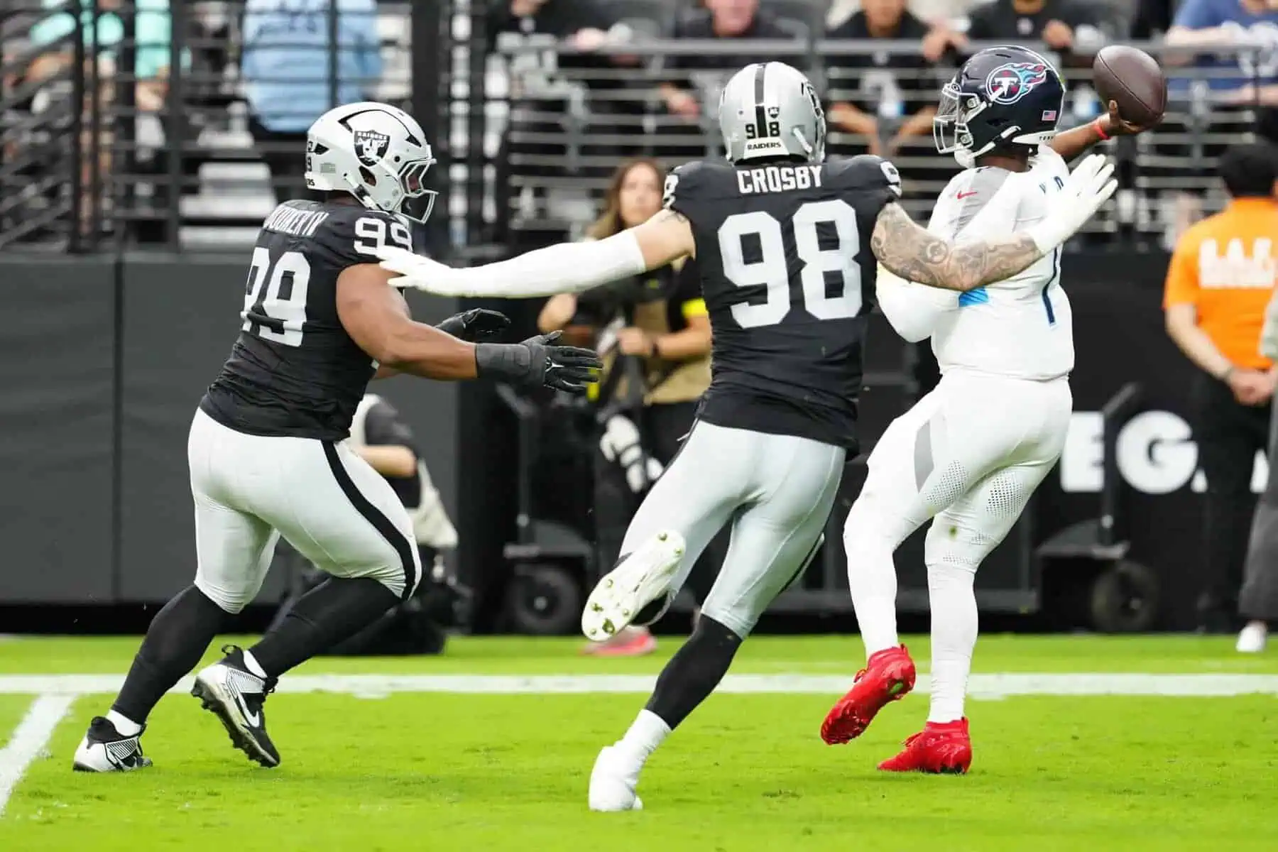 Las Vegas Raiders defensive end Maxx Crosby closes in on Titans QB Cam Ward Image by: Stephen R. Sylvanie-Imagn Images