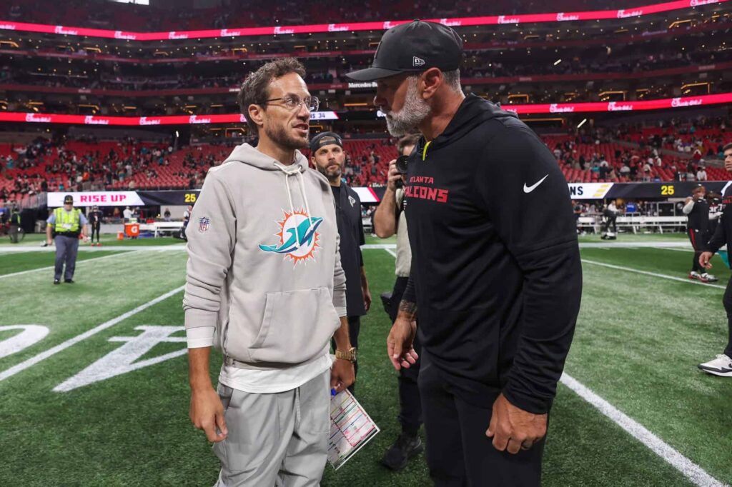 Mike McDaniel, then Miami Dolphins head coach, talks with Falcons coordinator Jeff Ulbrich after an October 2025 game