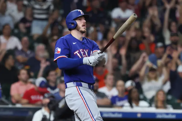 Texas Rangers catcher Jonah Heim swings the bat