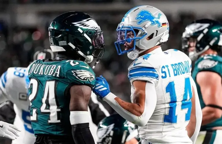 Eagles Andrew Mukuba talking with Amon Ra St. Brown