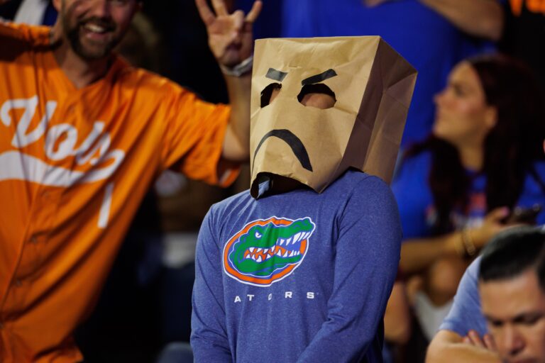 A Florida Gators fan wears a brown paper bag with a sad face against the Tennessee Volunteers at Ben Hill Griffin Stadium. Image by: Matt Pendleton-Imagn Images