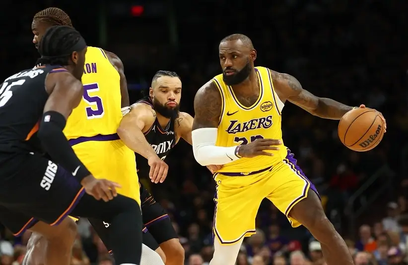 Los Angeles Lakers forward LeBron James (23) moves the ball against Phoenix Suns forward Dillon Brooks in the second half at Mortgage Matchup Center.