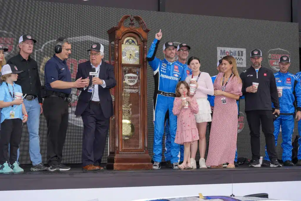 Mar 30, 2025; Martinsville, Virginia, USA; NASCAR Cup Series driver Denny Hamlin (11) and his family celebrate his win at the Cook Out 400 at Martinsville Speedway. Mandatory Credit: Jim Dedmon-Imagn Images