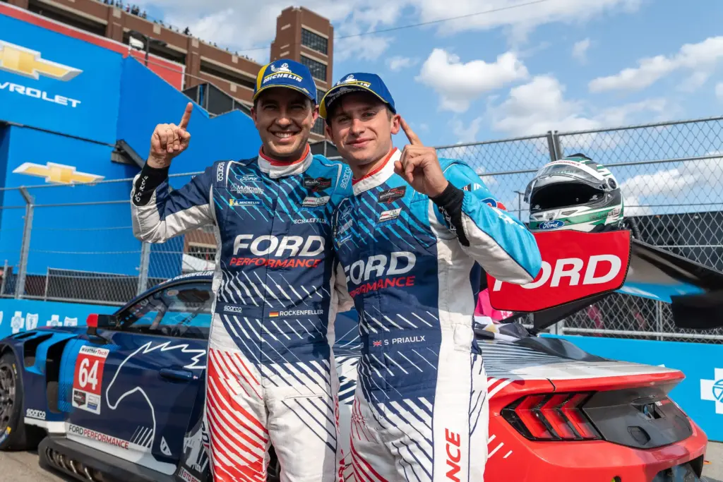 Mike Rockenfeller, left, celebrates with teammate Sebastian Priaulx after winning the GTD Pro Class in the Ford Mustang GT3 during the Chevrolet Detroit Sports Car Classic at the 2025 Detroit Grand Prix presented by Lear in Detroit on Saturday, May 31, 2025.