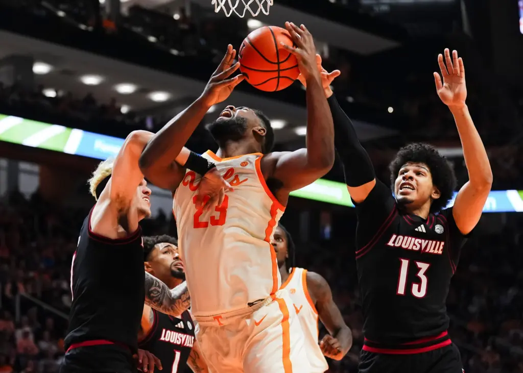 Tennessee forward Jaylen Carey (23) is fouled by Louisville forward Kasean Pryor (7) during a college basketball game between Tennessee and Louisville held at Thompson-Boling Arena at Food City Center in Knoxville, Tenn., on Dec. 16, 2025.