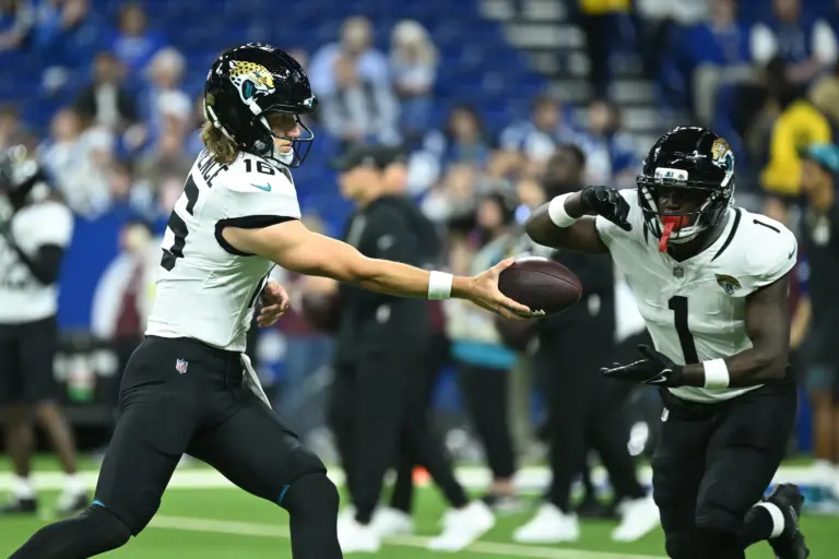 Dec 28, 2025; Indianapolis, Indiana, USA; Jacksonville Jaguars quarterback Trevor Lawrence (16) and running back Travis Etienne Jr. (1) warm up before a game against the Indianapolis Colts during the first half at Lucas Oil Stadium. Mandatory Credit: Robert Goddin-Imagn Images