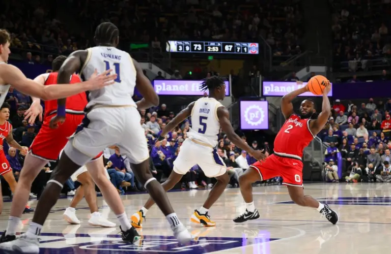 Jan 11, 2026; Seattle, Washington, USA; Ohio State Buckeyes guard Bruce Thornton (2) looks to pass the ball while guarded by Washington Huskies guard Zoom Diallo (5) during the second half at Alaska Airlines Arena at Hec Edmundson Pavilion.