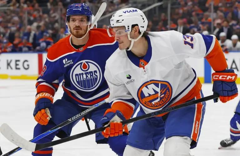 Jan 15, 2026; Edmonton, Alberta, CAN; New York Islanders forward Matt Barzal (13) and Edmonton Oilers forward Jack Roslovic (28) looks for a loose puck during the third period at Rogers Place.