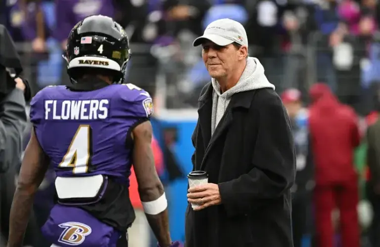 Baltimore Ravens owner Steve Bisciotti talks with wide receiver Zay Flowers