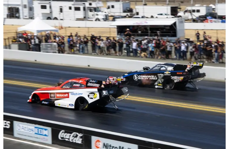Jul 28, 2024; Sonoma, CA, USA; NHRA funny car driver Bob Tasca III (near) races alongside Austin Prock during the Denso Nationals at Sonoma Raceway. Tasca Racing