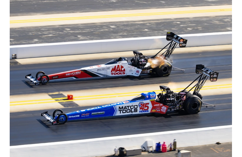 Sep 21, 2024; Concord, NC, USA; NHRA top fuel driver Antron Brown (near) alongside Doug Kalitta during the Carolina Nationals at zMax Dragway.