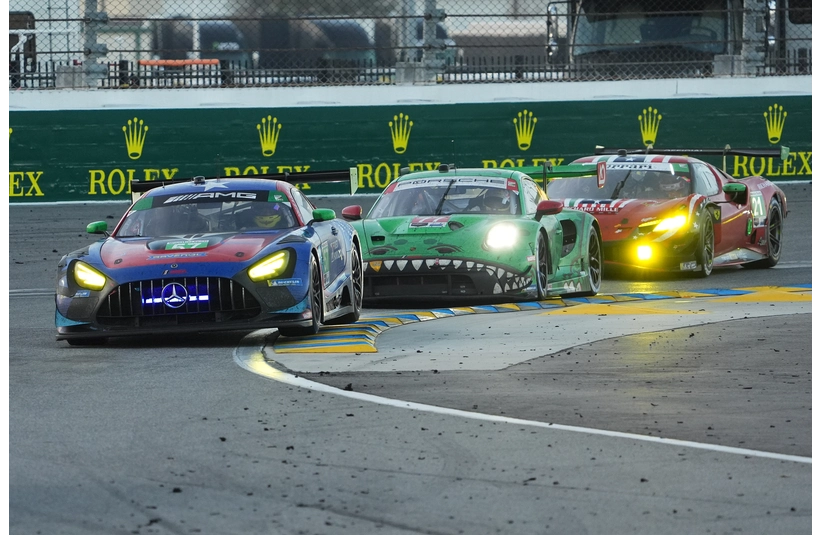 Jan 26, 2025; Daytona Beach, FL, USA; Winward Racing Mercedes AMG GT3 EVO of Russell Ward, Phillip Ellis, Indy Dontje, and Daniel Morad (57) leads AO Racing Porsche 911 GT3.R of Laurin Heinrich, Klaus Bachler, and Alessio Picariello (77) and c21
during the Rolex 24 at Daytona International Speedway.