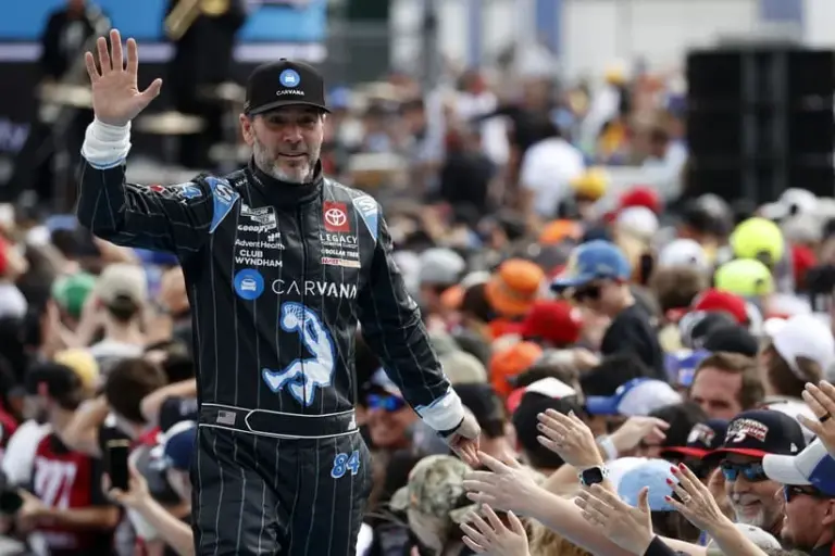 Daytona Beach, Florida, USA; NASCAR Cup Series driver Jimmie Johnson (84) walks onto the driver introduction stage to greet fans before the Daytona 500 at Daytona International Speedway.