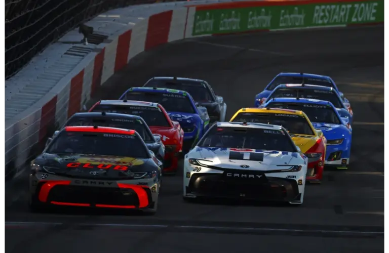 May 17, 2025; North Wilkesboro, North Carolina, USA; NASCAR Cup Series driver Chase Briscoe (19) and NASCAR Cup Series driver Christopher Bell (20) lead a restart during the heat races for the NASCAR All-Star race at North Wilkesboro Speedway.