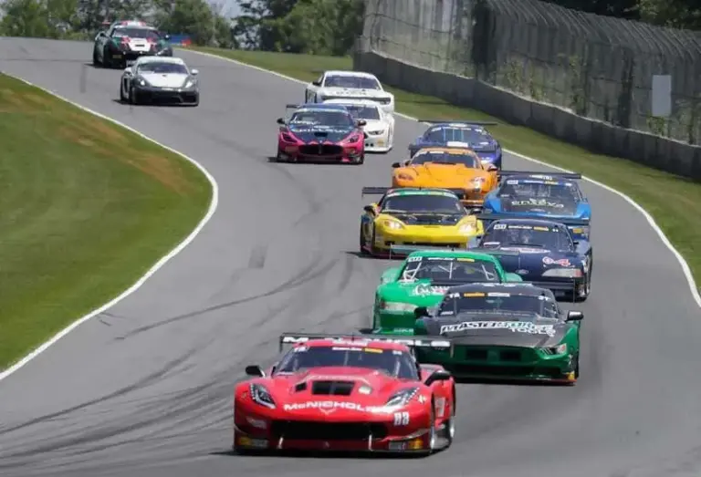 Tovo; Trans Am series cars warm up their tires during the parade lap during the Cheese Capital Cup at Elkhart Lake’s Road America near Elkhart Lake, Wis.