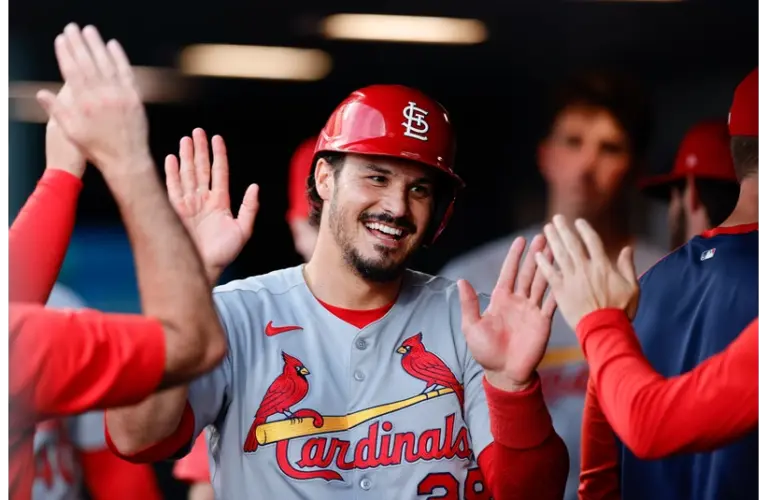 Newly acquired Diamondbacks third baseman Nolan Arenado celebrates in the dugout after scoring on an RBI in the fourth inning against the Colorado Rockies at Coors Field.