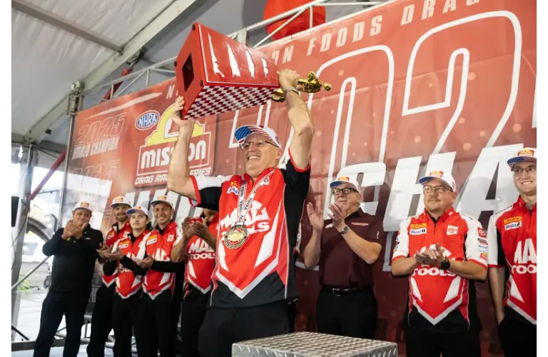 Nov 15, 2025; Pomona, CA, USA; NHRA top fuel driver Doug Kalitta celebrates with the trophy after clinching the 2025 NHRA top fuel world championship following qualifying for the NHRA Finals at In-N-Out Burger Pomona Dragstrip. Qualifying would be cancelled due to weather.