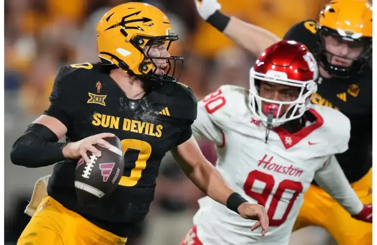 ASU Sun Devils quarterback Sam Leavitt (10) scrambles away from Houston Cougars defensive lineman Eddie Walls III (90) at Mountain America Stadium in Tempe on Oct. 25, 2025. Transferring to LSU.