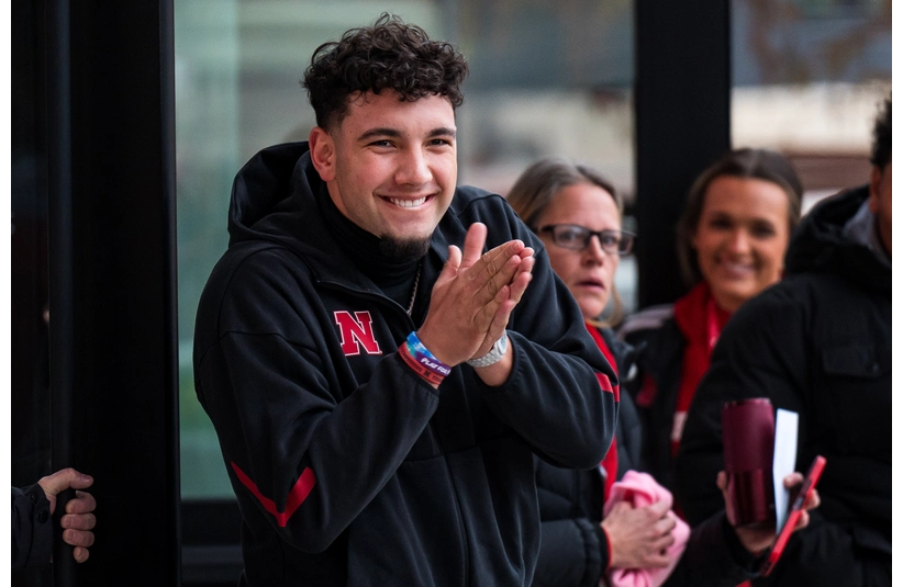 Nov 28, 2025; Lincoln, Nebraska, USA; Nebraska Cornhuskers quarterback Dylan Raiola (15) greets the team as the walk into the stadium before the game against the Iowa Hawkeyes at Memorial Stadium. Mandatory Credit: Dylan Widger-Imagn
