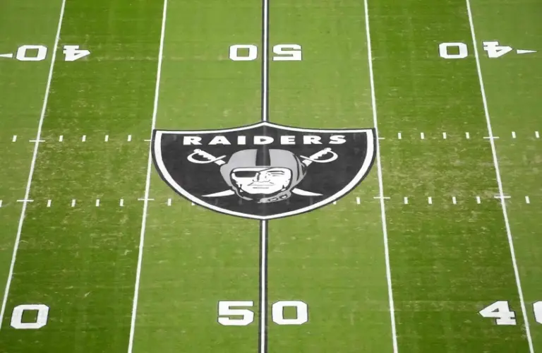 The Las Vegas Raiders shield logo at midfield at Allegiant Stadium