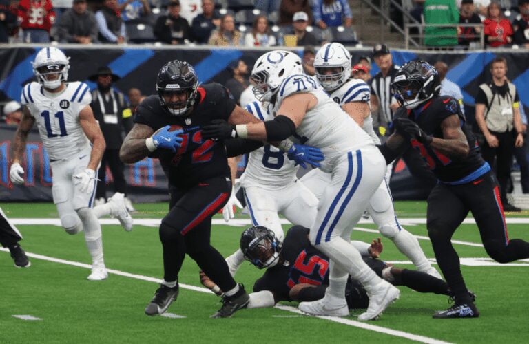 Colts player try to tackle Texan after fumble.