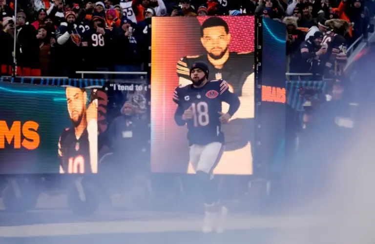 Chicago Bears quarterback Caleb Williams runs onto the field.
