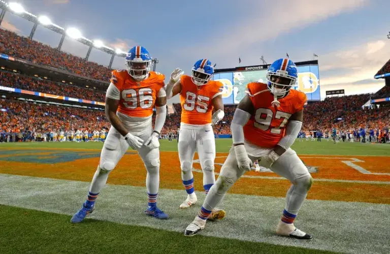 Denver Broncos defensive end Eyioma Uwazurike (96), defensive end Sai'vion Jones (95) and defensive tackle Malcolm Roach (97) reacts after a fumble recovery during the second half against the Los Angeles Chargers