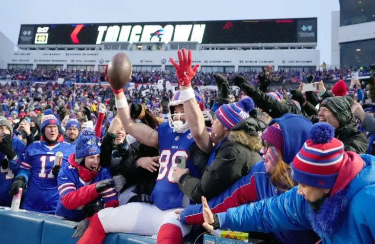 Bills player celebrates with crowd after touchdown.