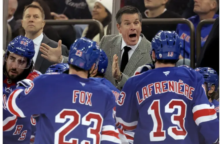 Rangers head coach Mike Sullivan talks to defenseman Adam Fox (23) and left wing Alexis Lafreniere (13) during a time out during the third period against the Utah Mammoth at Madison Square Garden.