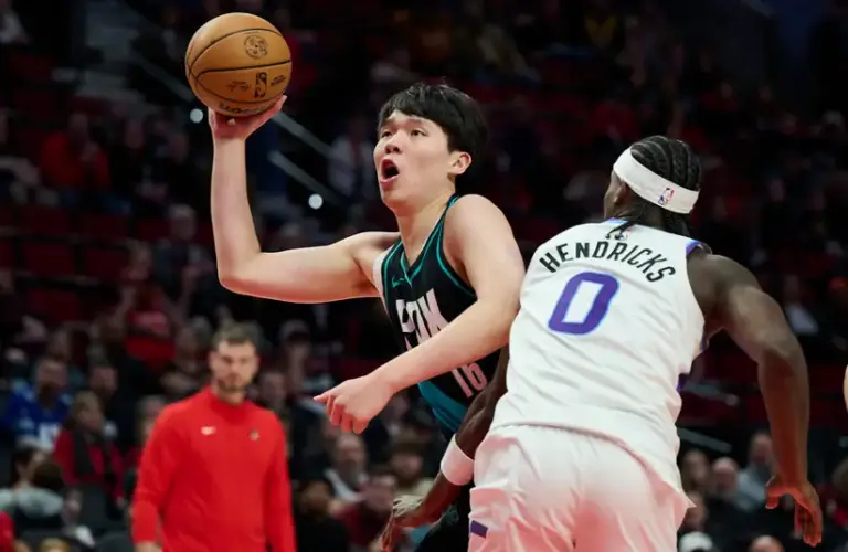 Former Spurs Center Yang Hansen (16) drives past Jazz F Taylor Hendricks (0).