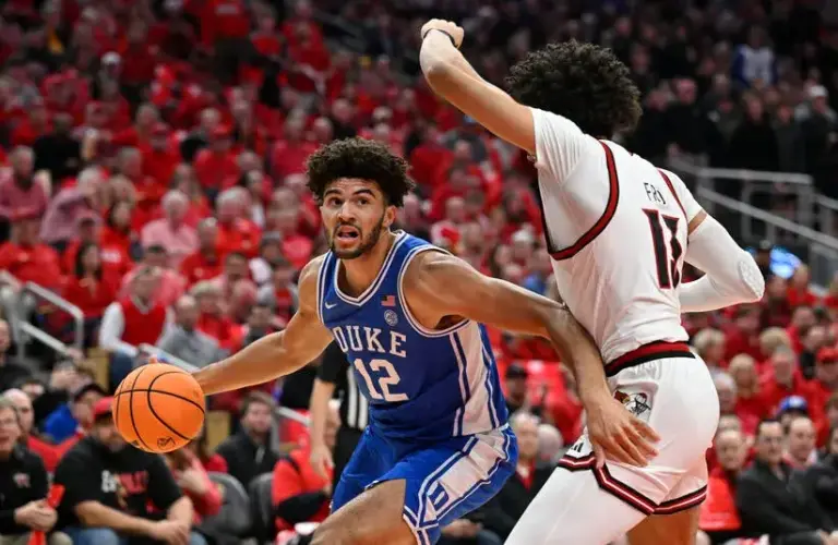 Duke Blue Devils forward Cameron Boozer (12) drives to the basket against Louisville Cardinals forward Sananda Fru (13) in the first half