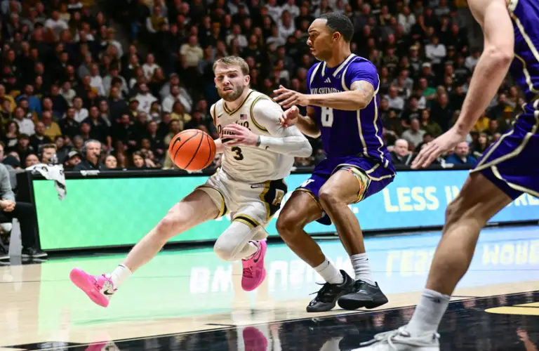 Purdue player Braden Smith drives to the basket on a Washington player.