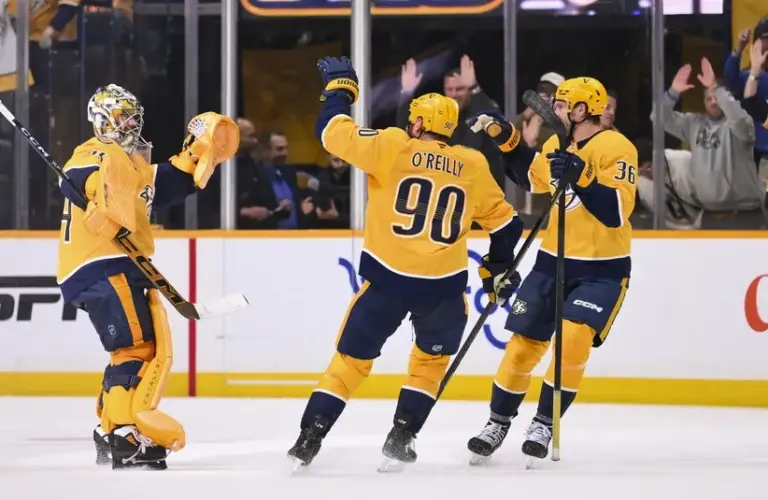 Nashville Predators goaltender Juuse Saros (74) celebrates the win with his teammates against the New York Islanders during the shootout.