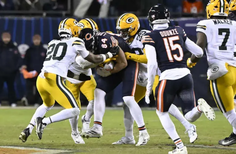 Chicago Bears tight end Colston Loveland (84) is tackled by Green Bay Packers safety Javon Bullard (20) and safety Xavier McKinney (29) during the first half of an NFC Wild Card Round game at Soldier Field.