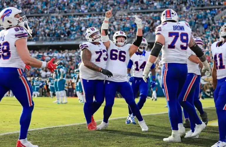 Buffalo Bills center Connor McGovern (66) celebrates a touchdown from Buffalo Bills quarterback Josh Allen (17), not shown, during the fourth quarter of an NFL Playoffs matchup.