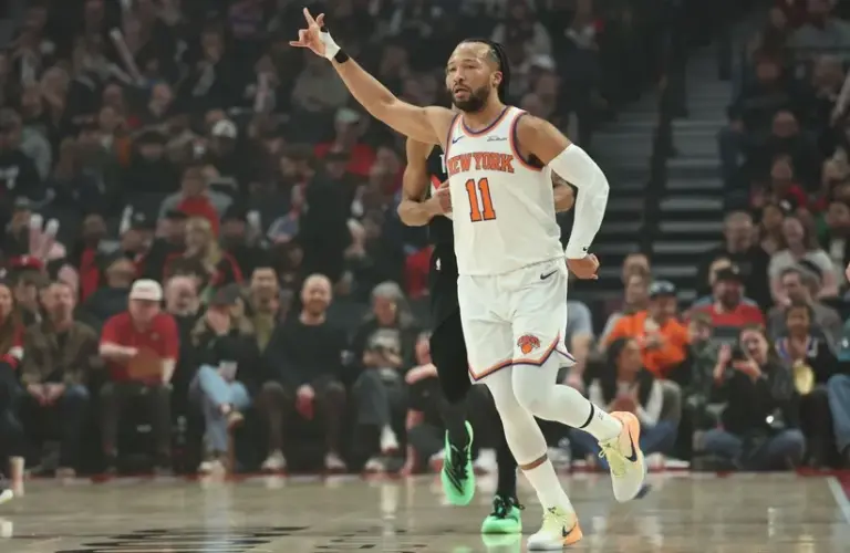 New York Knicks guard Jalen Brunson (11) reacts after scoring a three-point shot against the Portland Trail Blazers during the first half at Moda Center.