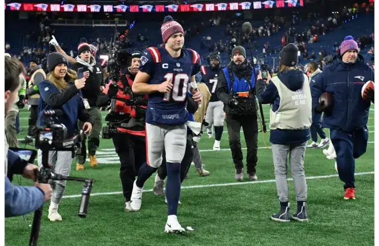 Patriots Drake Maye jogging off the field after Wild Card victory