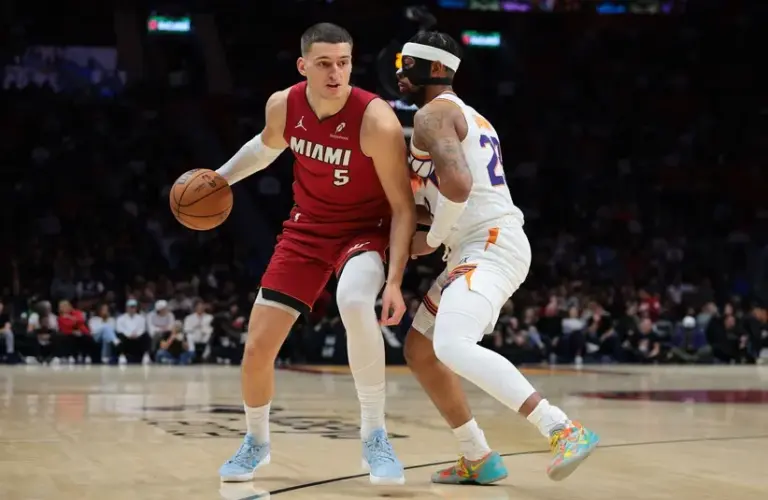 Miami Heat forward Nikola Jovic (5) drives to the basket against Phoenix Suns guard Jordan Goodwin (23) during the first quarter at Kaseya Center.
