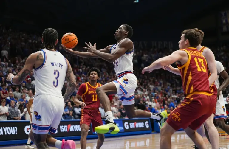 Kansas players goes up for a layup on Iowa State player.